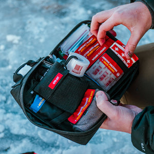 Man holding an open uncharted first aid pro