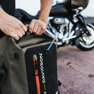 Man's arms opening an Uncharted/Harley-Davidson shell