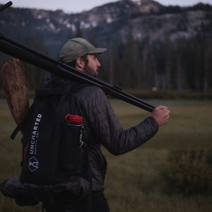 Man in meadow with tripod wearing a seventy2 pro