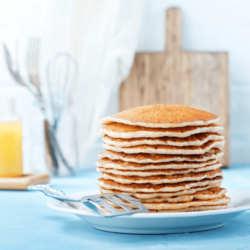 ReadyPantry One Month Food Supply, a tall stack of golden pancakes on a plate, a delicious food option
