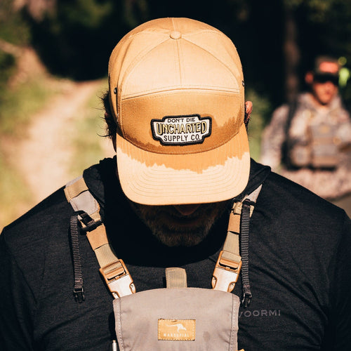 Navigator Hat, person wears sweat-stained tan Uncharted Supply Co cap while hiking