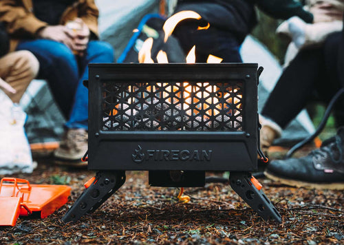 FireCan Rocks glowing in an Ignik FireCan portable fire pit, warming campers outdoors