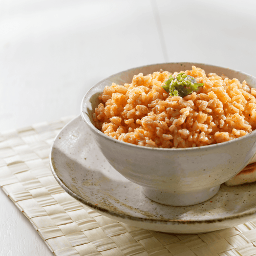 One Month Food Supply by ReadyPantry: a bowl of orange rice with green garnish, representing a survival meal