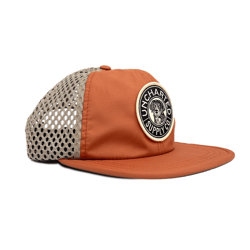 Trailblazer Performance Hat, orange outdoor cap with khaki mesh back, Uncharted Supply Co dog patch