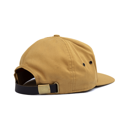 Navigator Hat, tan cap with black leather strap, brass buckle, and side vents