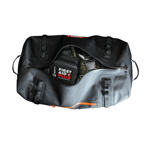Flood Prep Core kit: black & grey waterproof duffel bag open with Uncharted First Aid kit and survival gear