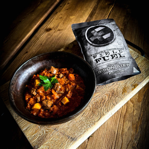 Essential Provisions BISON STEW ready-to-eat meal in a rustic bowl with packaging, for outdoor or emergency food