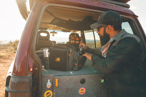 MAXTRAX Fuse Shackle off-road recovery gear being placed in Adventure Imports kit bag by man in SUV
