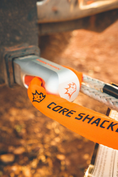 MAXTRAX Core Soft Shackle, orange, securing a synthetic recovery rope to a vehicle hitch