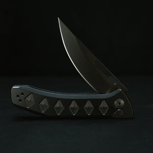 Half Face Blades Kwaiken Folder tactical knife, partially open, black nitride blade, anodized textured black handle