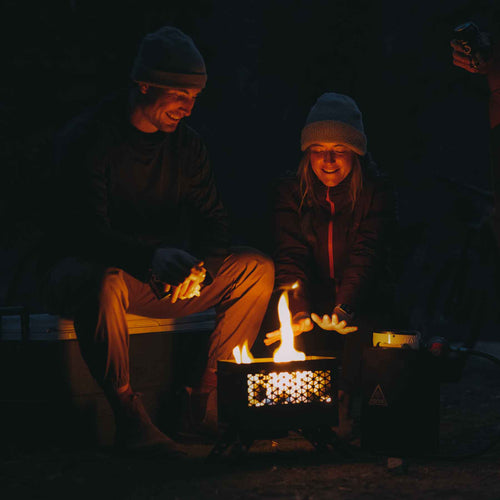 Ignik Outdoors FireCan portable propane fire pit heating happy campers outdoors at night