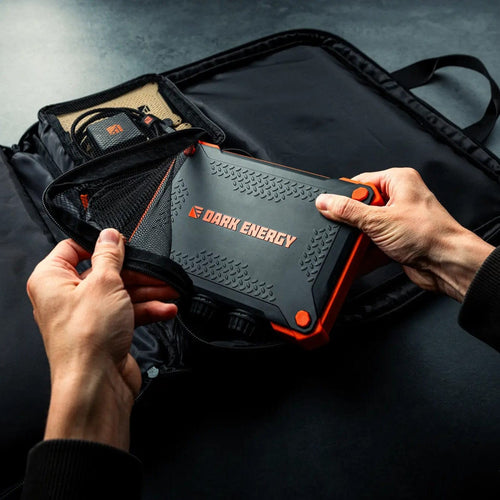 Dark Energy 56W Spectre Accessories Kit being placed in its durable carrying case, showing power bank & accessories