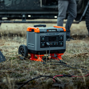 Dark Energy Recon 2000 portable power station, gray & orange, with wheel & multiple AC/USB outlets, used outdoors