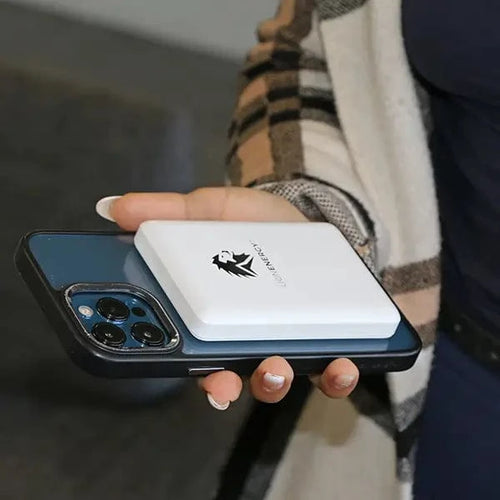 Lion Claw magnetic power bank by Lion Energy charging an iPhone, portable wireless charger