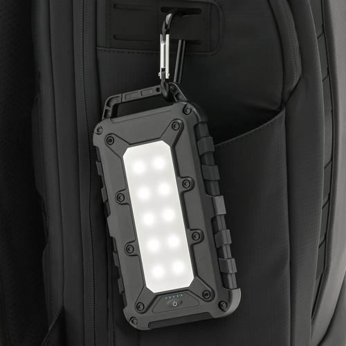 Lion Cub portable tactical lantern, 10 bright LEDs & battery status, clipped to a black backpack