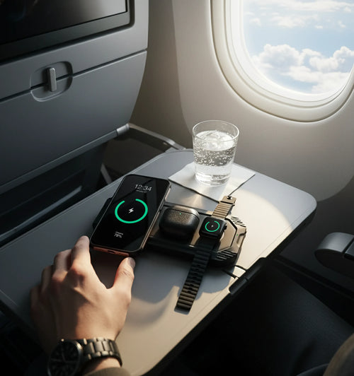 Lion Eclipse Mag travel 3-in-1 wireless charger on an airplane tray, charging phone, earbuds, watch