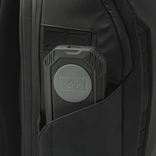 Lion Eclipse Mag rugged power bank with lion logo, partially inserted in black tactical backpack