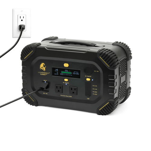 Lion Summit portable power station by Lion Energy, black with yellow accents, charging from a wall outlet