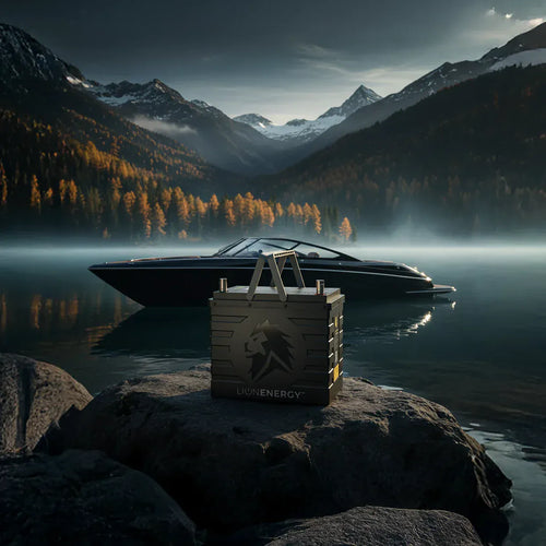 Lion Energy UT 1300 BT-H rugged portable power station on a rock by a boat on a misty lake