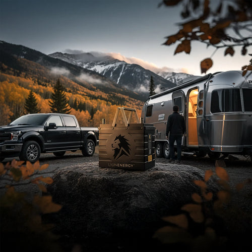 Lion Energy UT 1300 BT-H solar generator in a mountain camp scene with truck and RV
