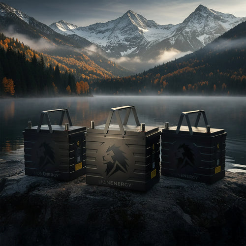 UT 1300 BT-H rugged portable power units by Lion Energy on a rocky shore, a misty lake, mountains, and autumn trees