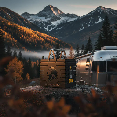 Lion Energy UT 1300 BT-H rugged portable power battery in a mountain forest with an RV