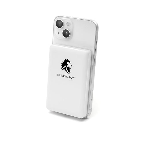 Lion Claw white MagSafe power bank by Lion Energy Staging, magnetically attached to a white iPhone