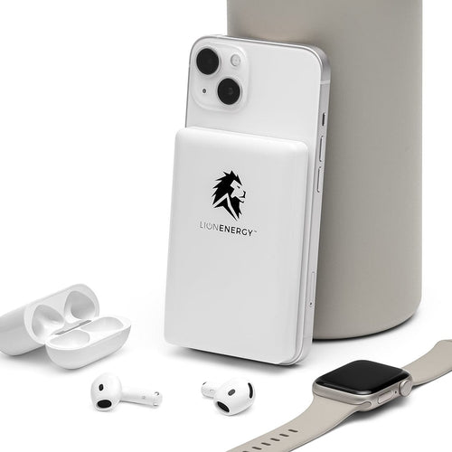 Lion Claw portable magnetic power bank by Lion Energy Staging charging phone, with earbuds and smartwatch