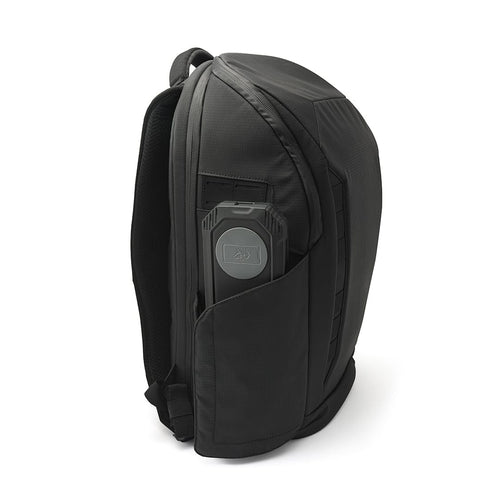 Lion Eclipse Mag portable power bank stored in a black technical backpack side pocket