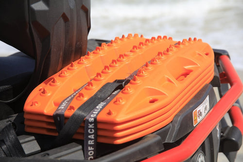 MAXTRAX Mini + JaxBase Combo orange traction boards secured to a vehicle rack, ready for off-road recovery