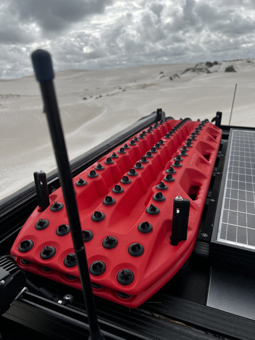 MAXTRAX XTREME Red Recovery Boards with black cleats on roof rack, off-road recovery in desert