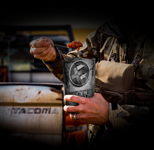 Essential Provisions Meal (Ready-to-Eat) VEGETABLE STEW from pouch eaten with spoon by person in camo outdoors