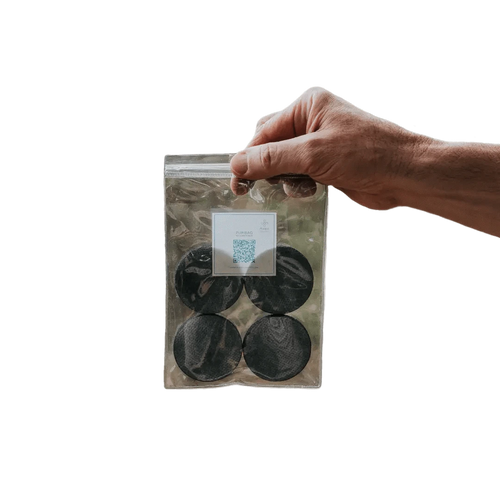 Puribag Filter Replacement Pack: hand holding clear bag with four round black water filter refills