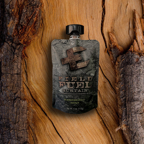 Essential Provisions Sustain Energy Blend pouch, Raspberry Mint flavor, on rustic wood