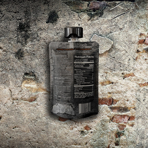 Essential Provisions Field Fuel Sustain Energy Blend pouch with nutrition facts & ingredients on a rustic brick wall