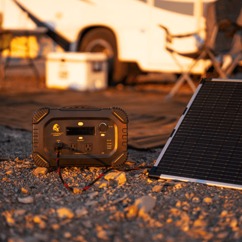Lion Summit portable power station charging via solar panel at a sunny campsite