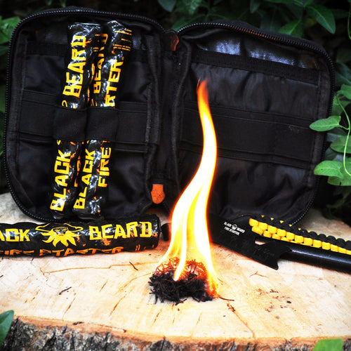 Black Beard Fire Starters Captain's Loot Kit tactical pouch open, fire starter burning, striker tool nearby on a log