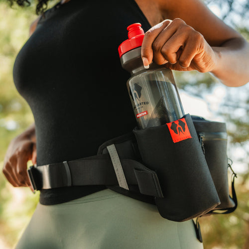 hiker wearing a park pack taking out one of the water bottles