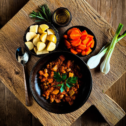 Hearty VEGETABLE STEW by Essential Provisions, pre-cooked meal with fresh ingredients on a wood board