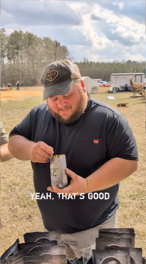 Essential Provisions Meal (Ready-to-Eat) Vegetable Stew, man eating MRE from pouch outdoors