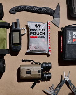 Various Uncharted Supply Co. products including possibles pouch, first aid pro, park pack surrounded by uncharted approved products
