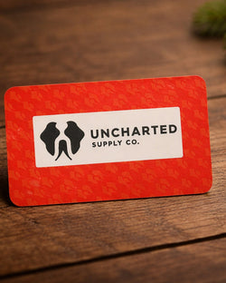 Uncharted Supply Co gift card on wood floor
