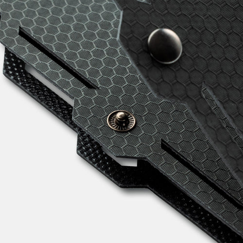 Dark Energy Spectre 18W, a rugged product featuring a dark gray hexagonal pattern and a metal snap closure