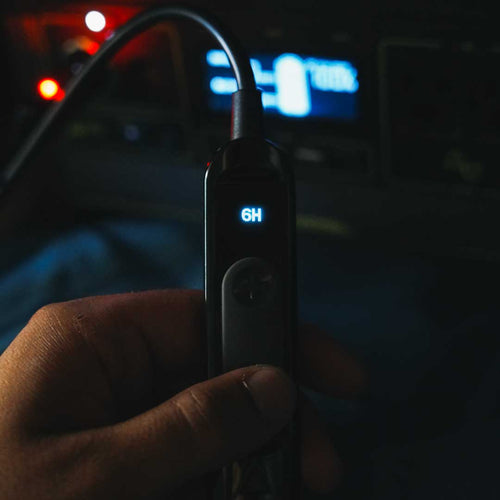 Topside Heated Blanket: Hand holds black power controller with '6H' display in dark for camping heated blanket