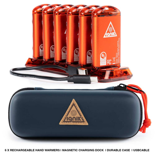 Six Ignik Ripple Rechargeable Hand Warmers charging in dock with USB cable, shown with durable travel case