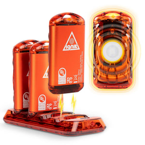 Ripple Rechargeable Hand Warmers by Ignik, three orange units on a charging base, one glowing