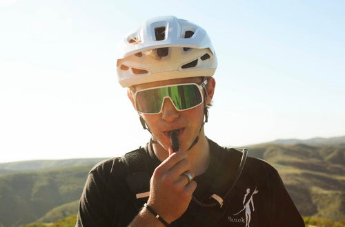 Puribag Adventure Pack hydration backpack used by male biker drinking from water bladder