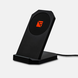 Mavrik Stand by Dark Energy, a black wireless charging phone stand with an orange geometric logo and power cord