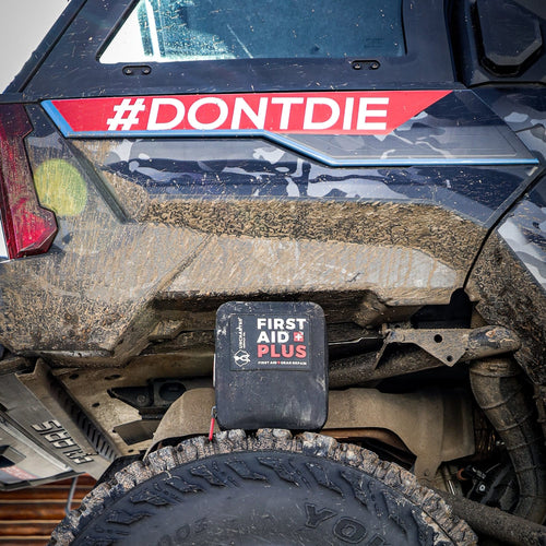 First aid plus sitting on the tire of a very muddy UTV