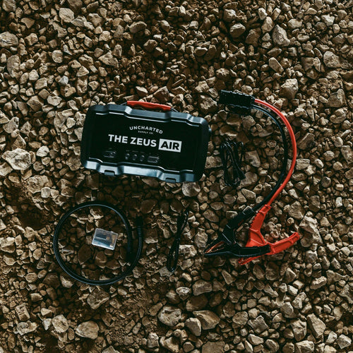 Zeus Air laying on rocks with all of it's accessories next to it